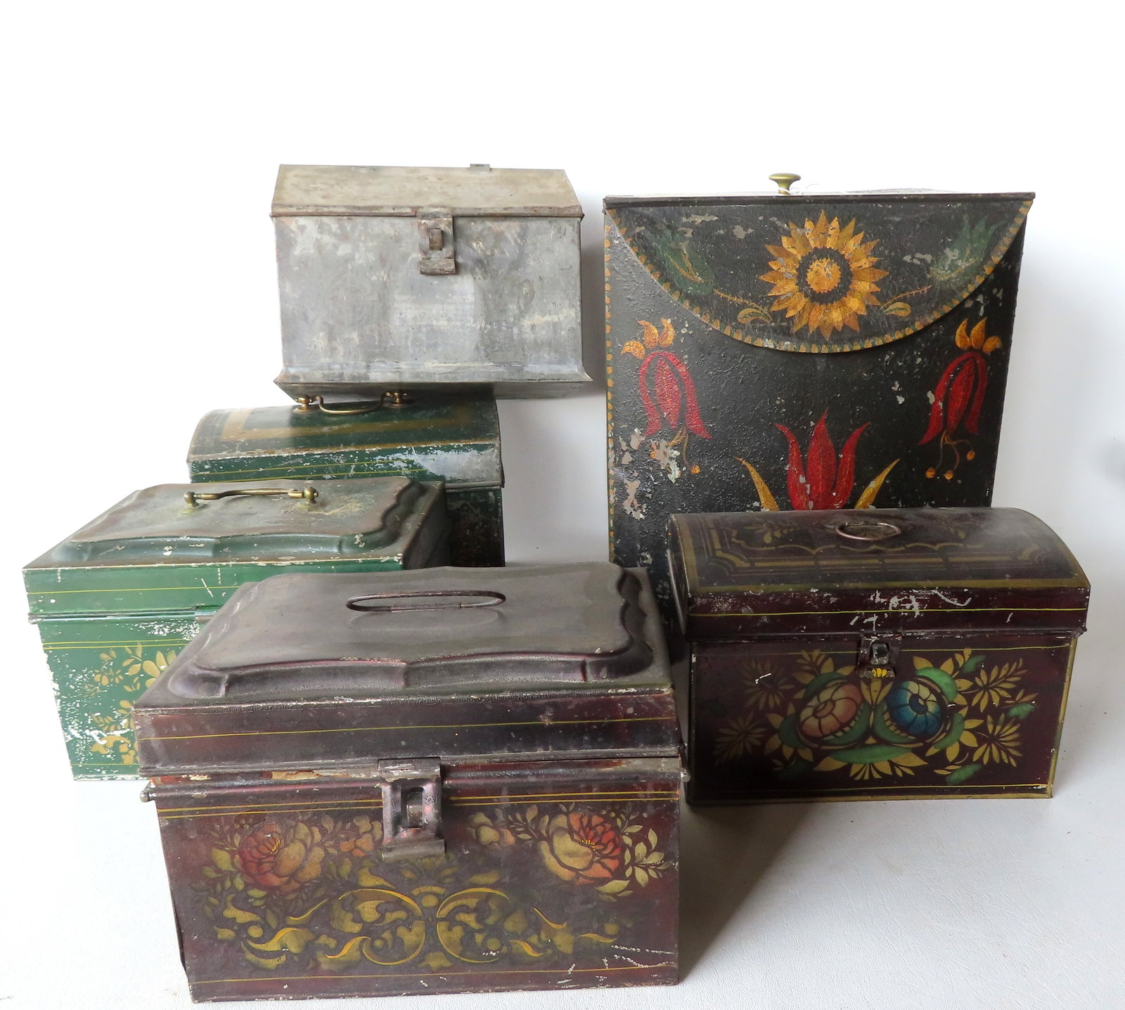 Six pieces of 19th century toleware in original paint. The largest is the stenciled and hand painted: Six pieces of 19th century toleware in original paint. The largest is the stenciled and hand painted tea box with some losses to paint - measures 11 1/2" square x 14"H. One house shaped tin with losse