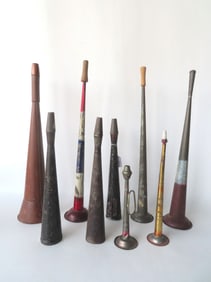 Grouping of 9 toleware horns, 19th century. Includes 2 in original red, white and blue paint with