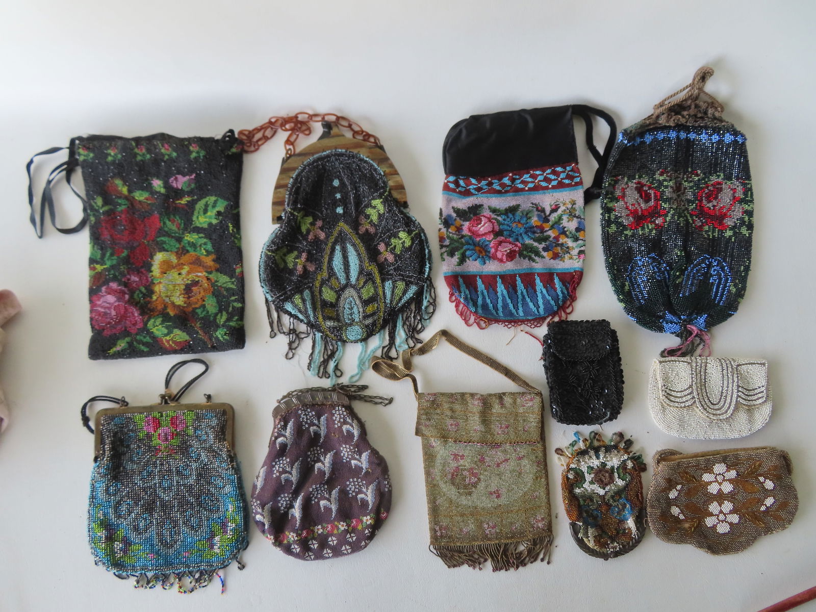 Grouping of 11 vintage beaded evening bags, most Art Deco design, circa 1930. One with small tear at: Grouping of 11 vintage beaded evening bags, most Art Deco design, circa 1930. One with small tear at opening in top, several with minor bead losses to hanging fringe, and 2 others with losses only to