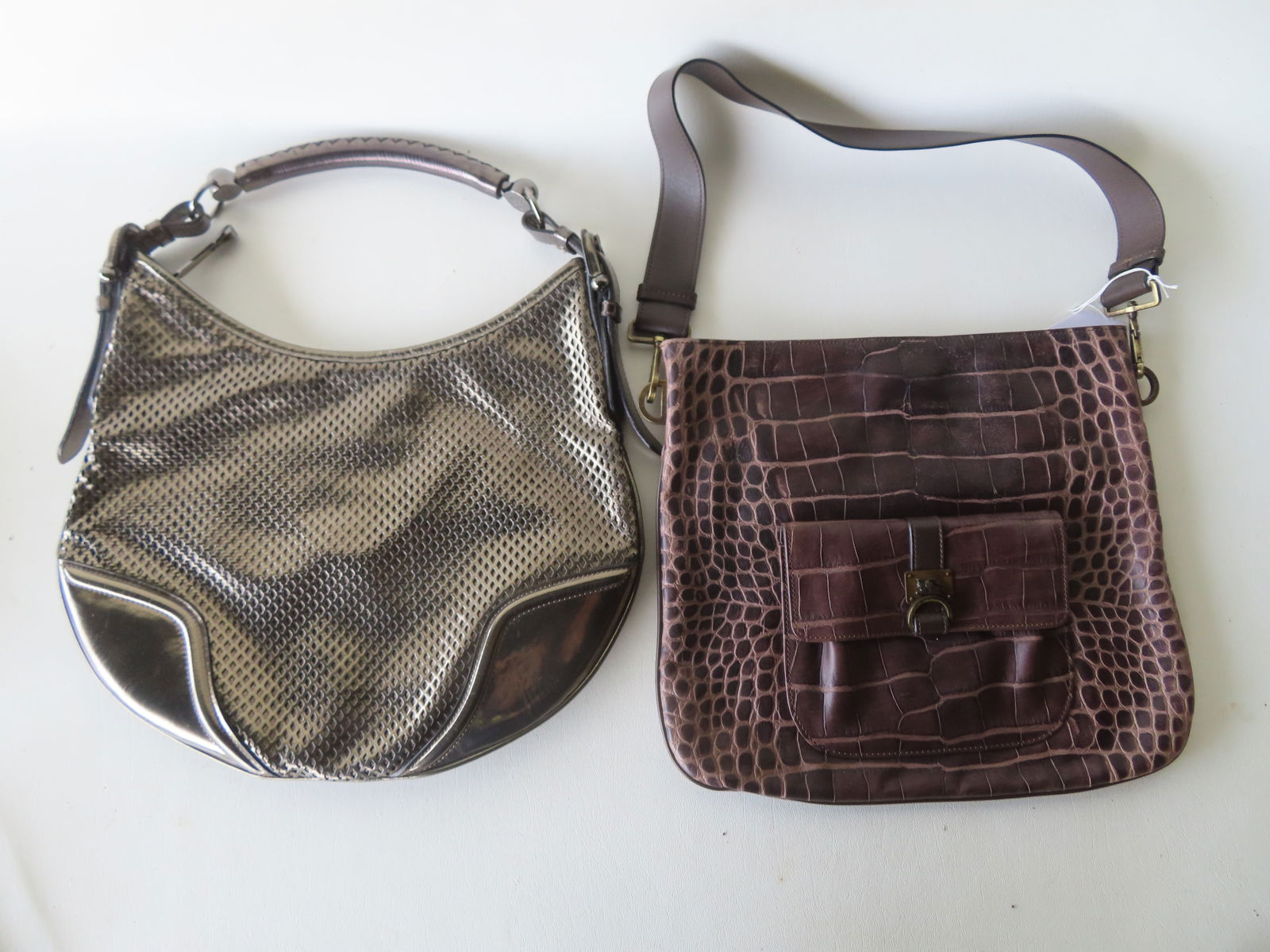 Two signed Burberry (London) lady's shoulder/hand bags. The first, a leather shoulder bag with faux: Two signed Burberry (London) lady's shoulder/hand bags. The first, a leather shoulder bag with faux reptile design - very good condition - measures 13"W x 11 1/2"H - sold with original dust bag; the s