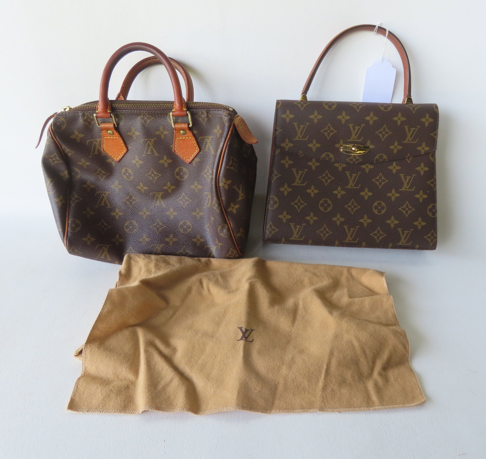 Two Louis Vuitton monogrammed lady's handbags, both in good condition. The largest measures 10 1/4"W: Two Louis Vuitton monogrammed lady's handbags, both in good condition. The largest measures 10 1/4"W x 13"H to top of single handle. Provenance: Partial contents of a Sherman CT estate, name withheld 