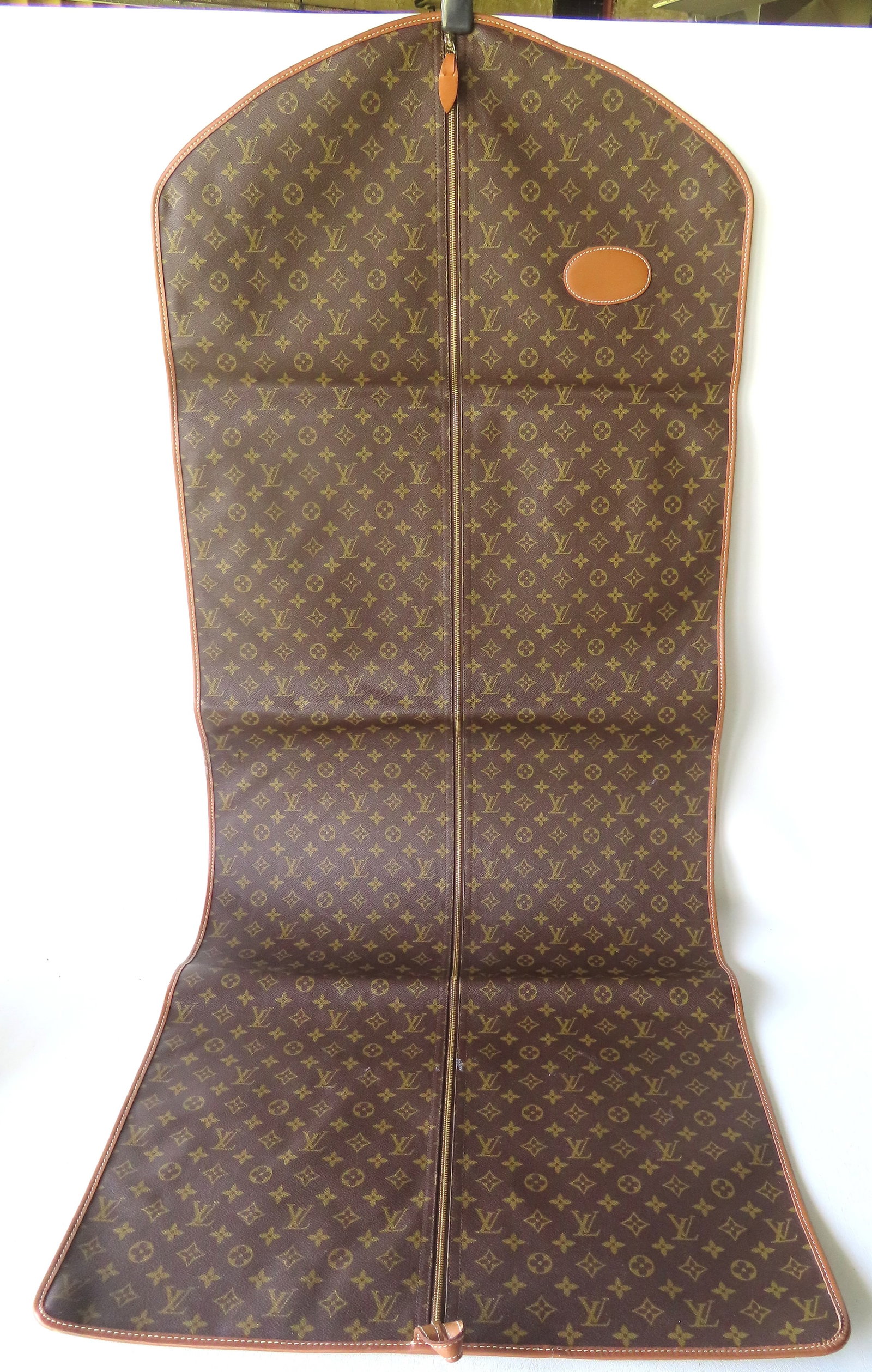 A Louis Vuitton monogrammed travel garment bag - a small blemish in leather on reverse side hardly: A Louis Vuitton monogrammed travel garment bag - a small blemish in leather on reverse side hardly noticeable, otherwise excellent condition. Measures approximately 59"H x 24"W. Provenance: Partial co