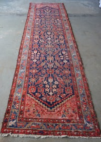 An oriental runner, hand knotted, late 19th to early 20th century. Minor use wear. Measures 11' 11"