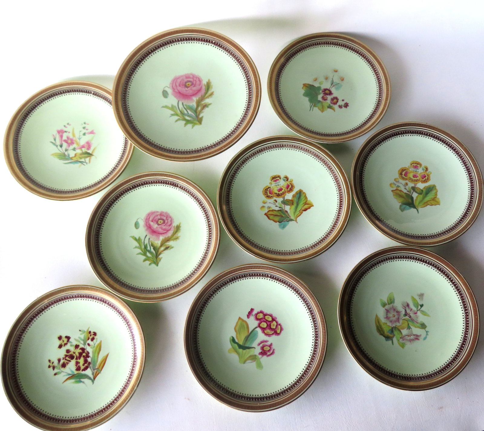 A porcelain luncheon set consisting of 8 hand painted floral plates, 9 1/8" diameter, and a matching: A porcelain luncheon set consisting of 8 hand painted floral plates, 9 1/8" diameter, and a matching compote - 9 1/2" diameter x 5 1/4"H. Unknown mark on base, possibly German, late 19th century. Thre
