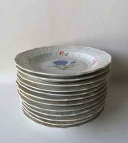 A set of 12 Meissen luncheon plates decorated with hand painted flowers - blue cross sword mark on