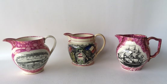 Three Sunderland pink luster creamers, including: The first marked "The Sailor's Return / Crimea" -