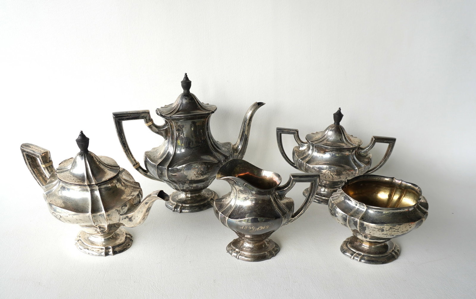 T.S. & Co. sterling silver 5 piece tea service including teapot, coffee pot, waste bowl, and lidded: T.S. & Co. sterling silver 5 piece tea service including teapot, coffee pot, waste bowl, and lidded sugar and creamer. All pieces with engraved monogram (either an F or an I), and also engraved "1894-