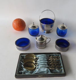 A sterling silver 6 piece condiment set with cobalt blue glass inserts, together with a boxed set of