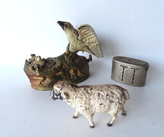 Three vintage banks, including: Cast iron sheep in original white paint, early 20th century; a cast