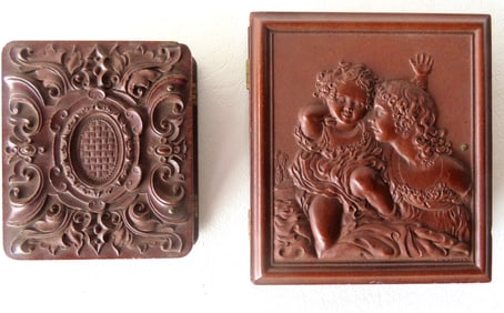 Two very fine brown gutta percha photo cases, both in very good condition. The largest with embossed
