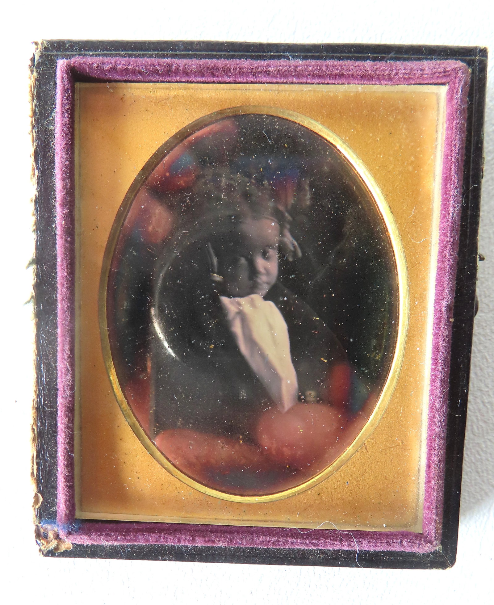 A Daguerreotype of a young dark skinned girl, ninth plate size. A very crisp image but hard to tell: A Daguerreotype of a young dark skinned girl, ninth plate size. A very crisp image but hard to tell if her eyes are open or closed, possibly a post mortem image. Top cover has separated, else very goo