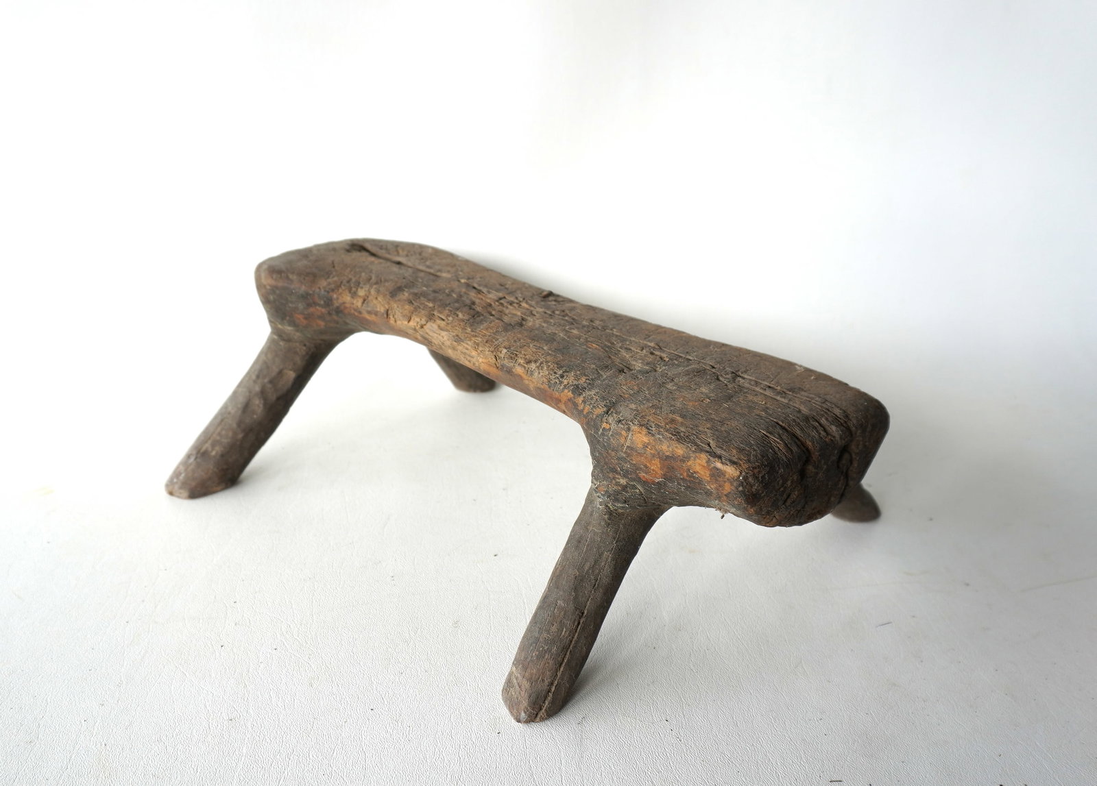 An unusual small size farm made wooden chopping block, natural formation from tree trunk: An unusual small size, very primitive, wooden farm made chopping block, natural formation from tree trunk with splayed legs. Lots of use wear and overall good condition, probably early 18th century. M