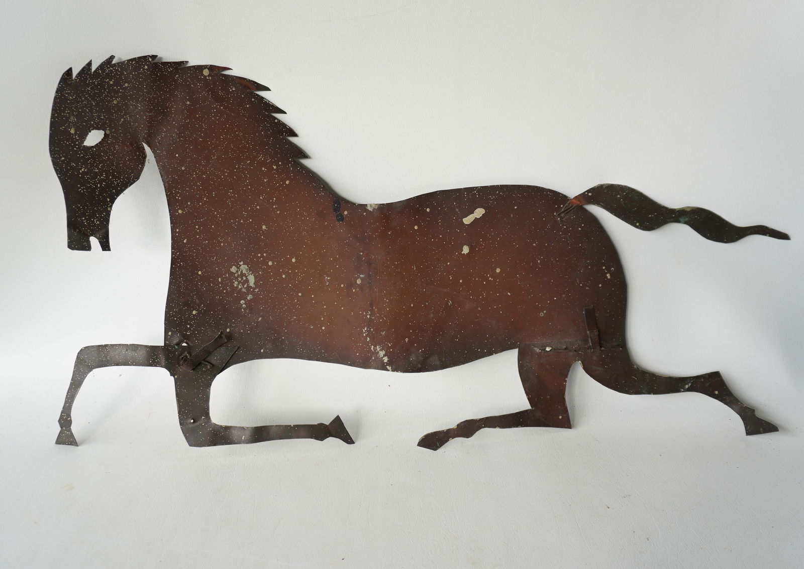 A patinated copper silhouette running horse weathervane pattern, early 20th century.: A patinated copper silhouette running horse weathervane pattern, early 20th century, good condition. Measures 32 1/2"L x 16 1/4"H. Provenance: From the Marni Bakst and William Sadler collection of ant