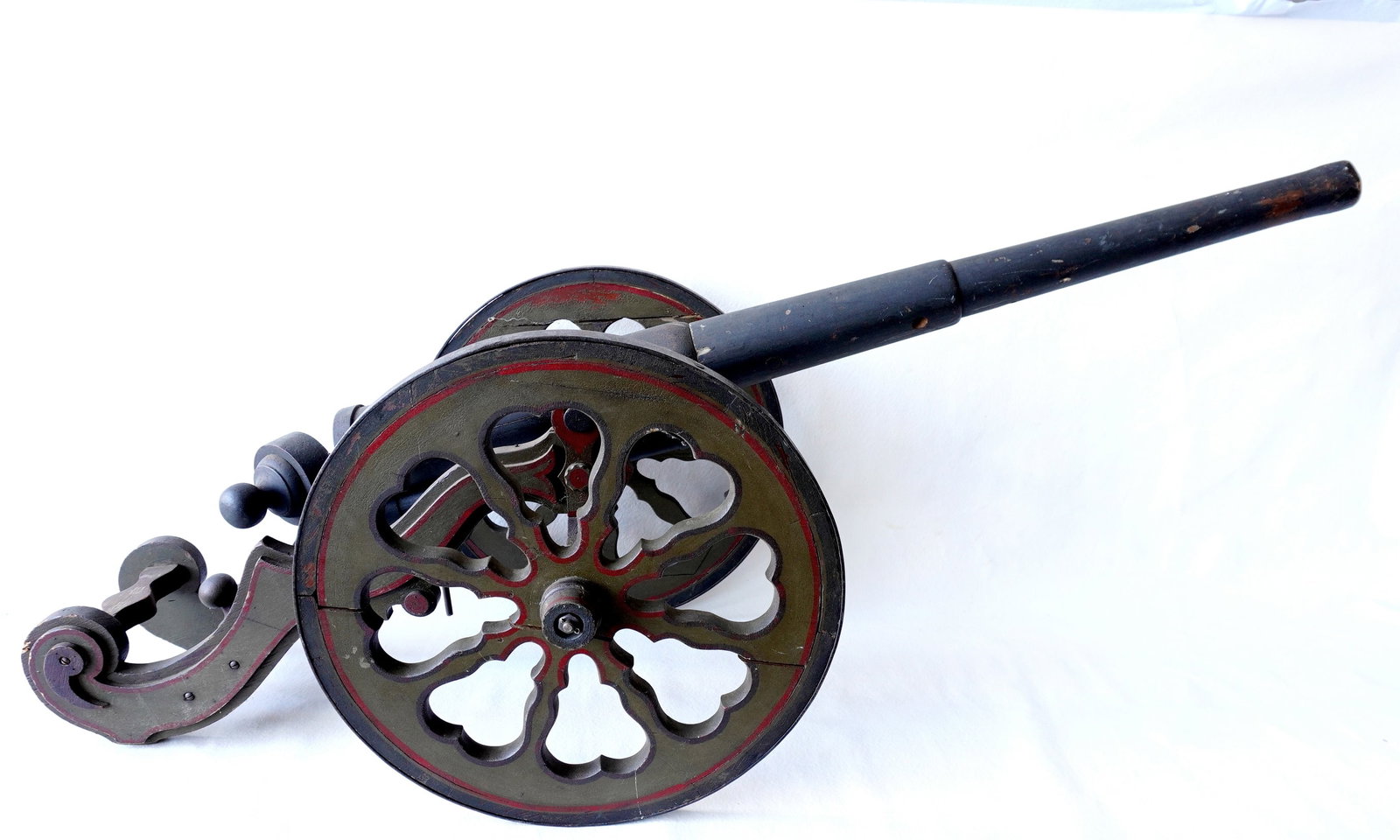 A hand made breech loading wooden cannon model in original paint, 19th century.: large hand made wooden breech loading cannon model in original paint and original double wheel carriage - the circular end of the breech with operating door with cascable to allow the shell to be inse