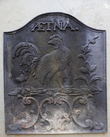 A newer cast iron fireback signed "AETNA", marked reverse "Winterthur Museum Reproduction"