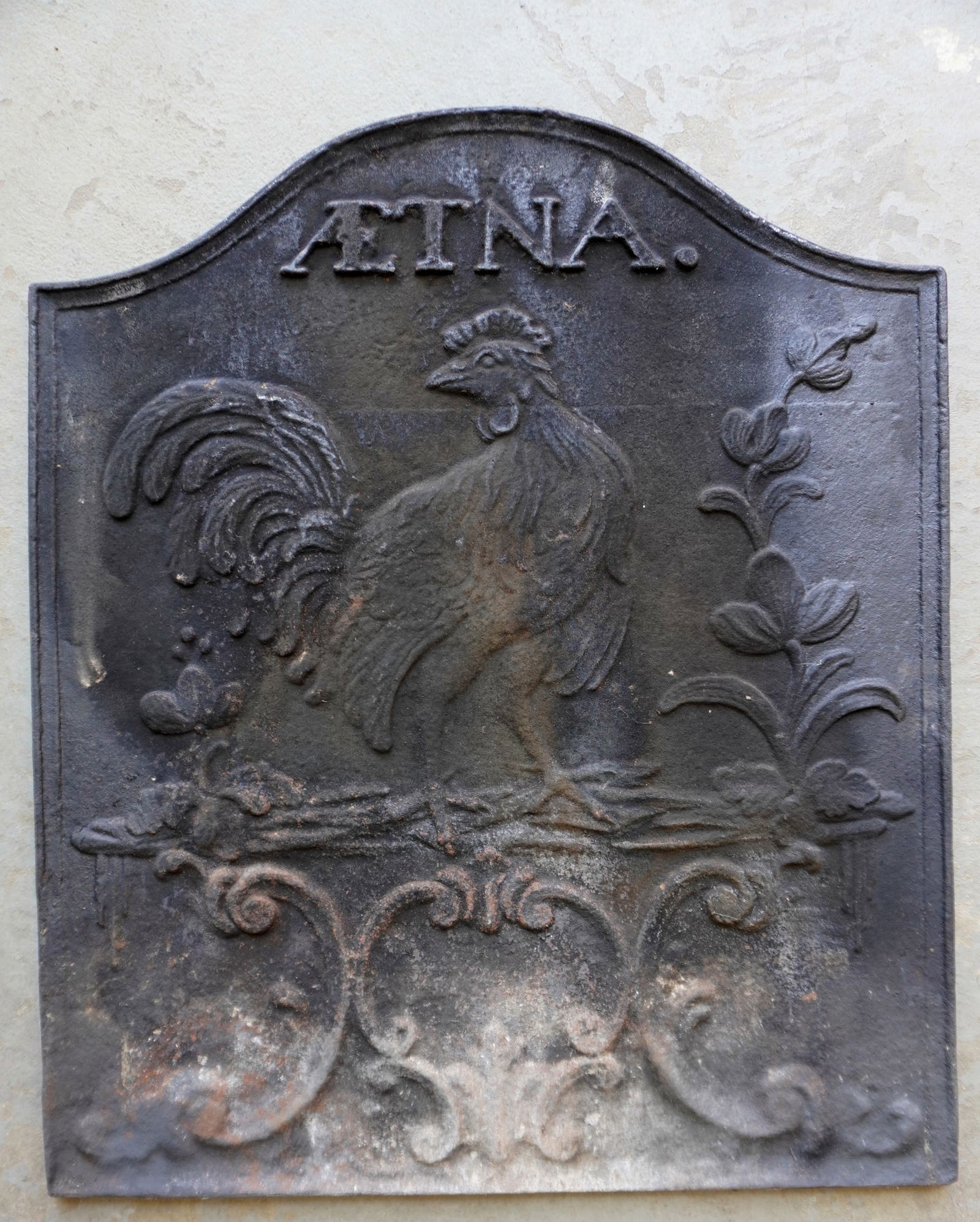 A newer cast iron fireback signed "AETNA", marked reverse "Winterthur Museum Reproduction": A newer cast iron fireback signed "AETNA" over an embossed rooster, and signed on reverse "Winterthur Museum Reproduction" (AETNA FURNICE, PHILADELPHIA founded in 1766) - very good condition. Measures