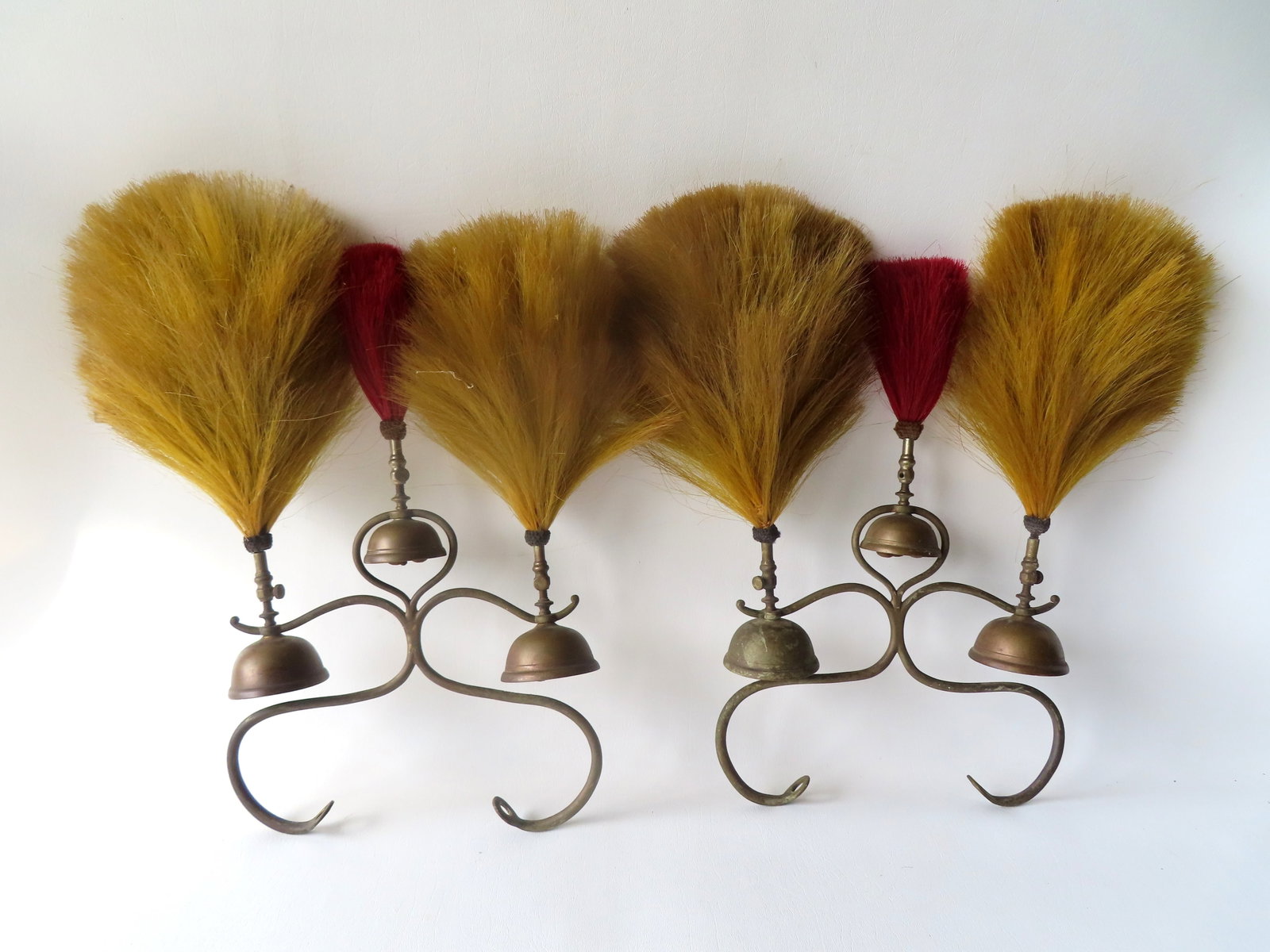 A matched pair of vintage sleigh or carriage bells, 19th century.: A hard to find matched pair of vintage sleigh or carriage bells, 19th century, each with 3 units and with dyed horse hair embellishments mounted to the top of each bell - both in very good condition, 