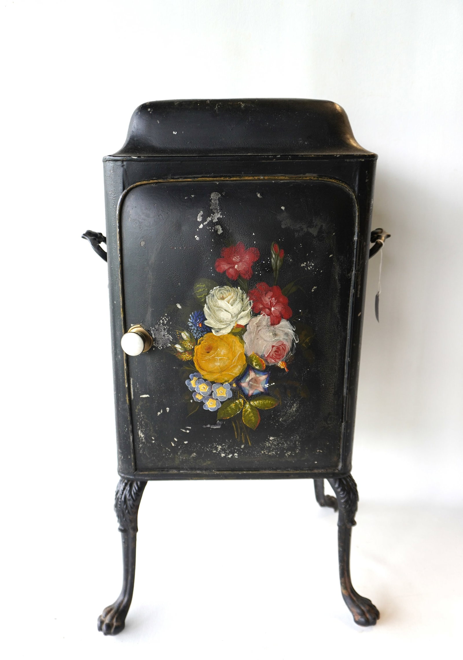 A Federal Tin Plate Warmer, hand painted, early 19th century.: A hand painted Federal floor standing tin plate warmer decorated with hand painted flowers on the front door panel and top, and mounted on iron cabriole legs with acanthus decorations on knee, leading