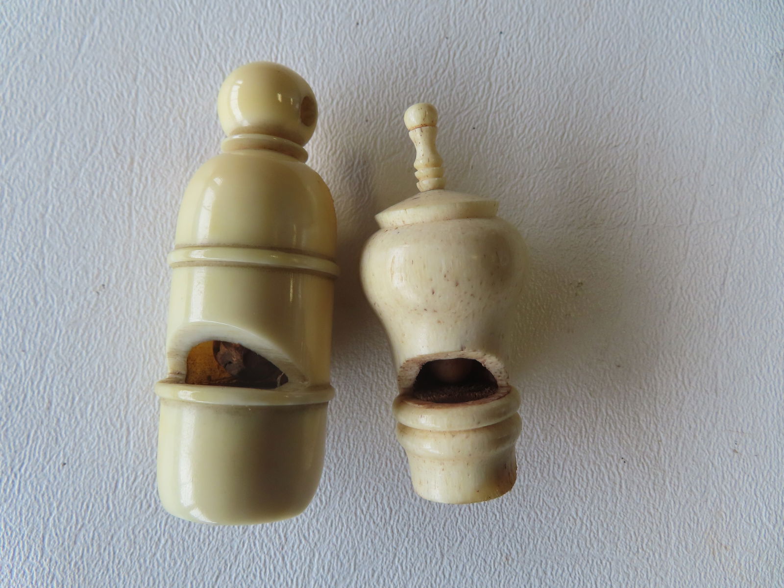 Two whistles, 1 in bone and 1 in walrus ivory, early to mid 19th century. Both in working condition,: Two whistles, 1 in bone and 1 in walrus ivory, early to mid 19th century. Both in working condition, with good patina and use wear consistent with age. The largest measures 2 1/2"L.Provenance: From th