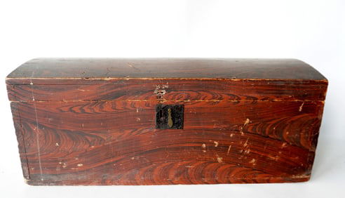 A grain painted dome top box in original red/black paint, dovetailed frame, mid 19th century. Missin