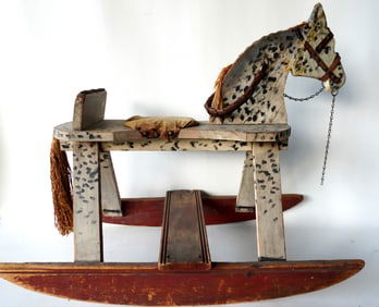 A folk art hand made dapple gray hobby horse in original paint.