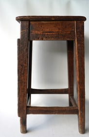 A very primitive 18th century tradesman stool with worn cross stretchers