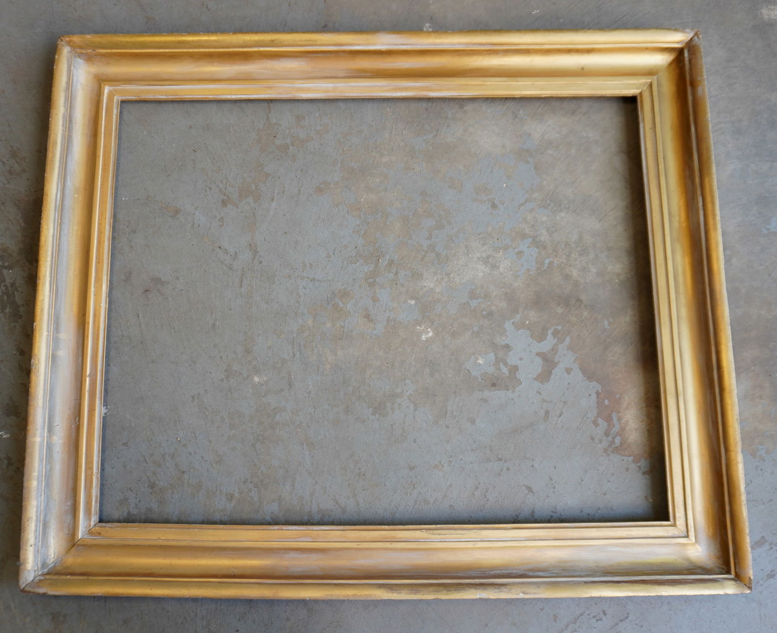 A very large lemon gold frame, mid 19th century.: A very large lemon gold frame, mid 19th century. The gold color with surface wear in several areas exposing the primary coat of silver gilting, but appears all original and in good condition. Overall