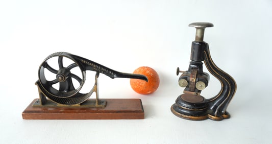 Two cast iron mechanical country collectibles: Enterprise cork roller & date stamp.