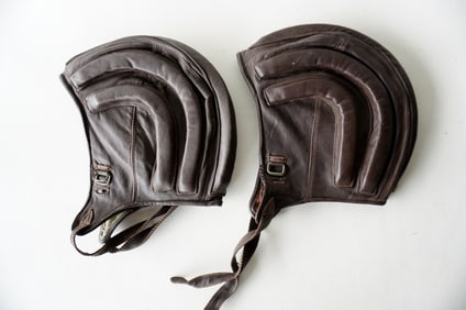 Two vintage leather helmets, possible for airplane pilot.