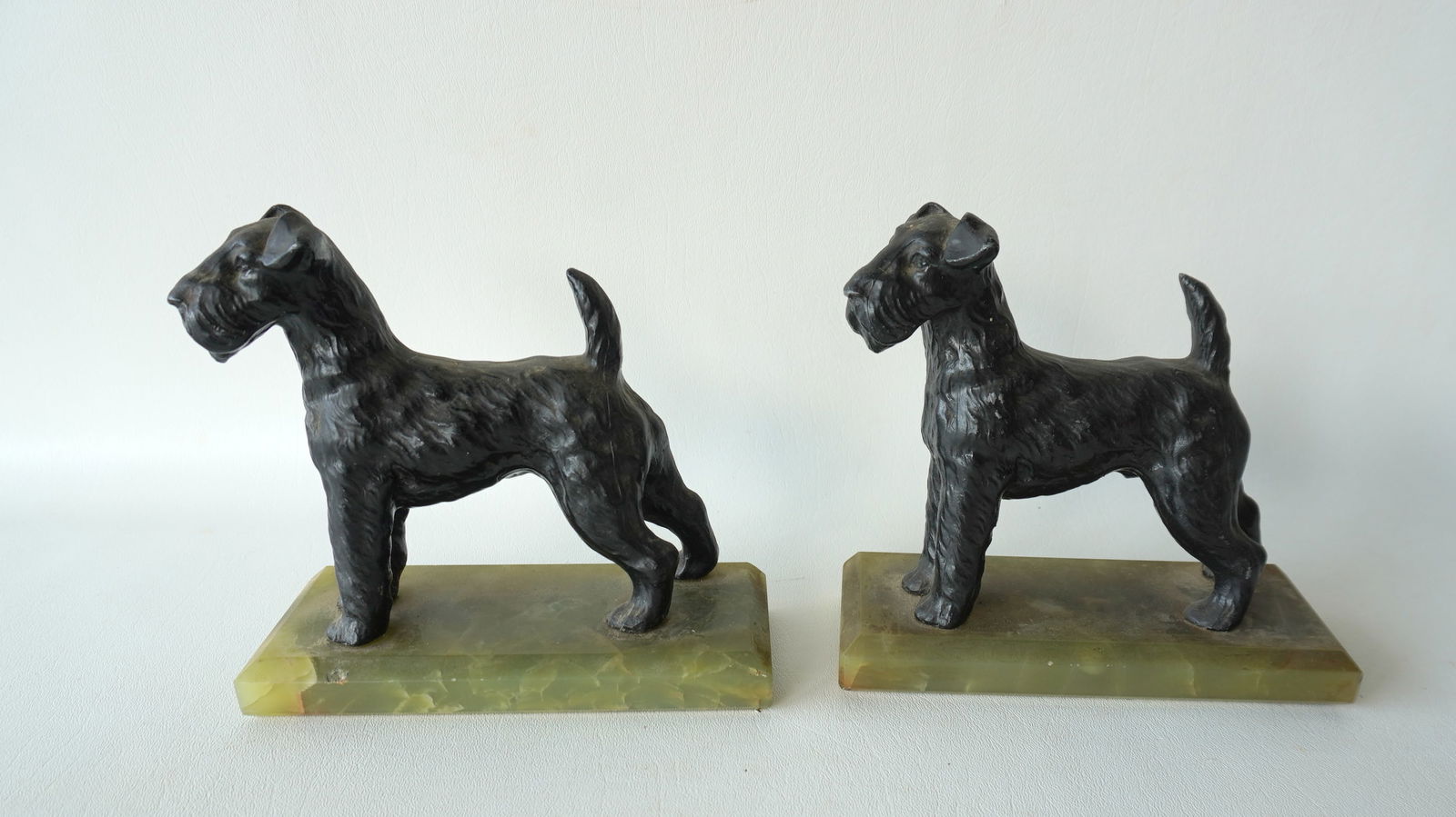A pair of Scottie dog bookends mounted on green alabaster bases, circa 1930.: A pair of Scottie dog bookends in original black paint, mounted on green alabaster bases, circa 1930. One with a tiny flake off the edge of base, hardly noticeable, else both in very good condition, n