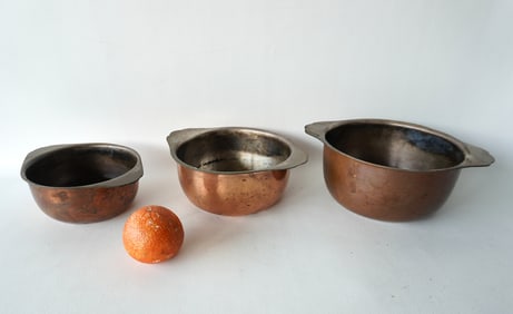 A nested set of 3 Arts & Crafts copper mixing bowls, signed Jos. Heinrichs NY.