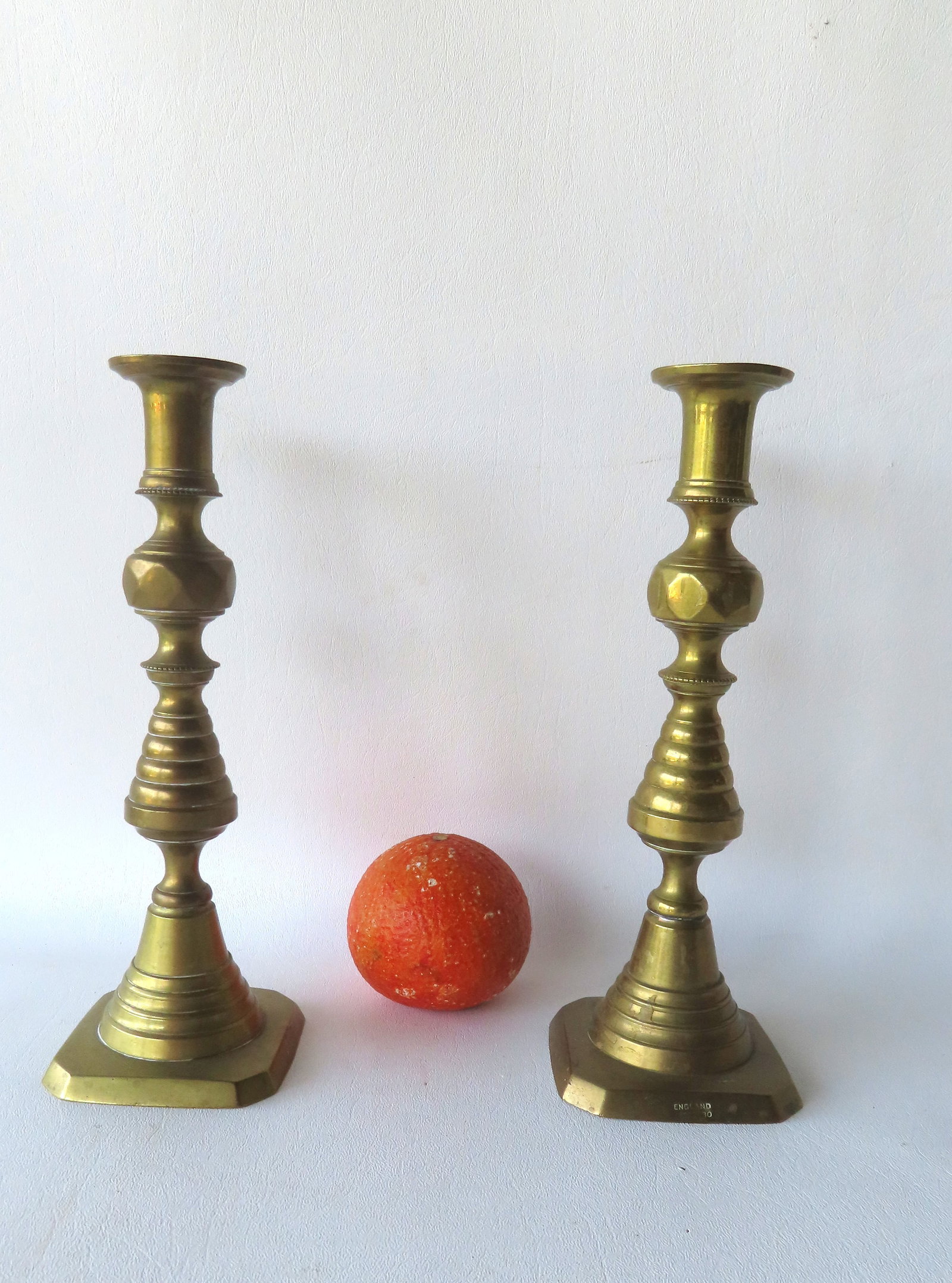A pair of brass pushup candlesticks, beehive pattern, marked "England".: A pair of brass pushup candlesticks, beehive pattern, marked "England" with registry number - both in very good condition, circa 1850.