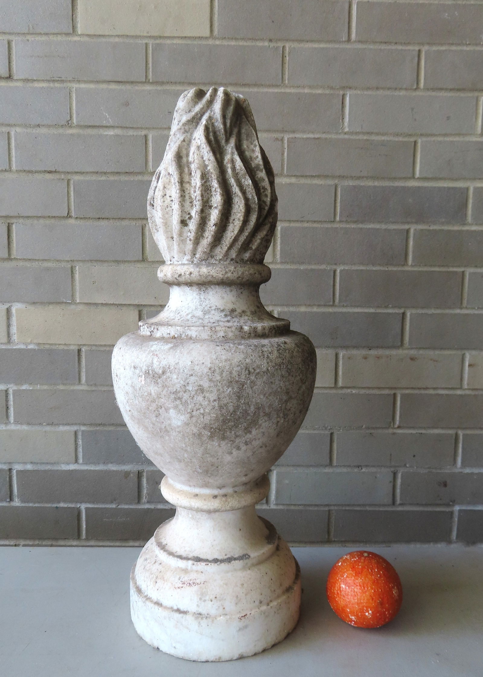 A carved marble or limestone finial in the form of a torch extending from bulbous turned base, mid