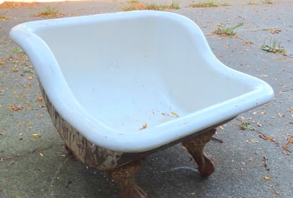 An enameled cast iron sits bath mounted on claw and ball iron feet , early 20th century. Original