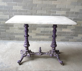 A marble top table with fancy cast iron double pedestal base with cross stretcher, 19th century.