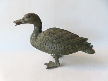 A very fine figural hollow bronze water fountain in the form of a duck with detailed casting and
