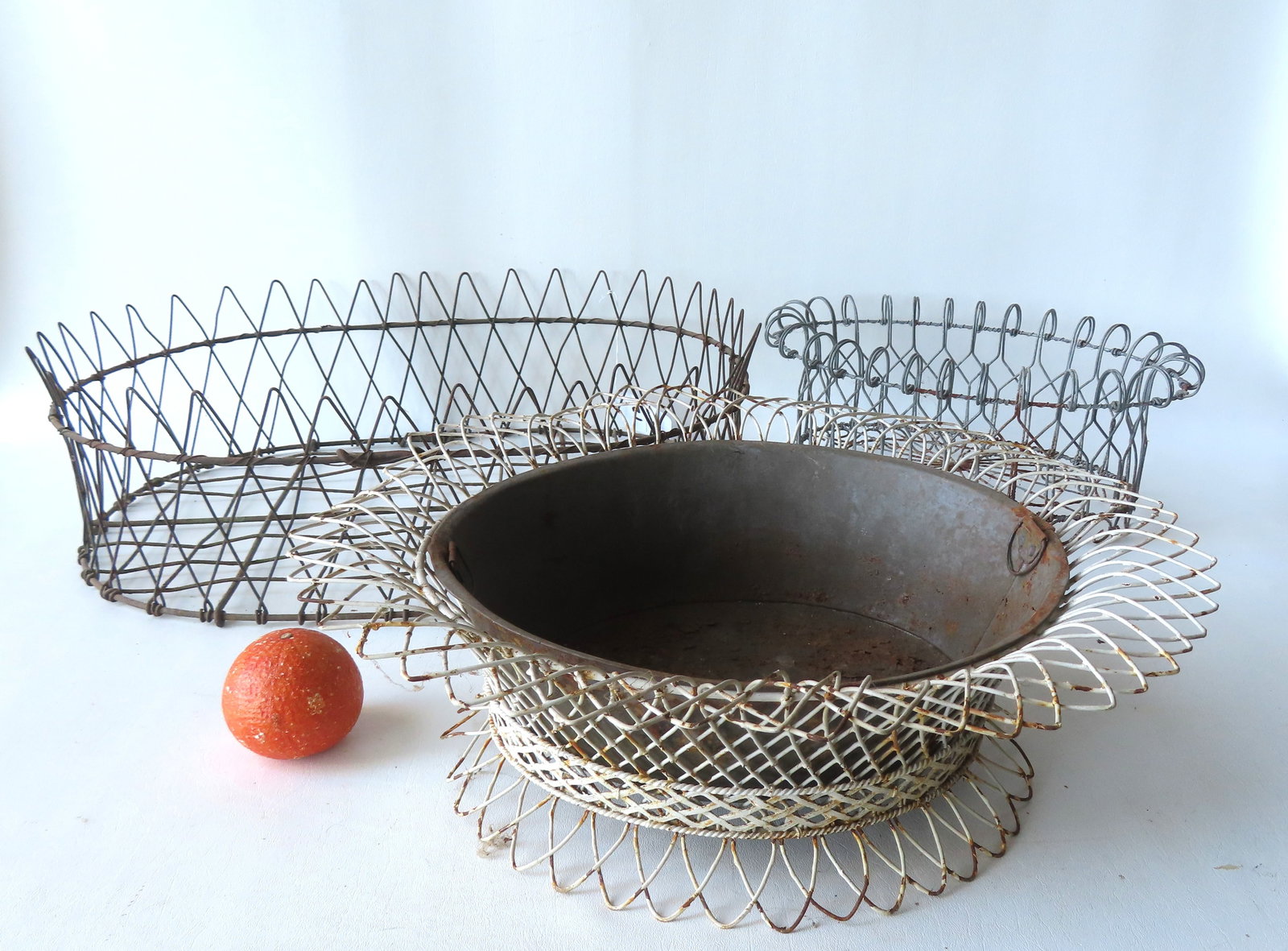 Three wire basket form plant holders, early to mid 20th century, all in good condition. The largest: Three wire basket form plant holders, early to mid 20th century, all in good condition. The largest measures 22"L x 16 1/4"W x 6 3/4"H. Provenance: From the Marni Bakst and William Sadler collection o