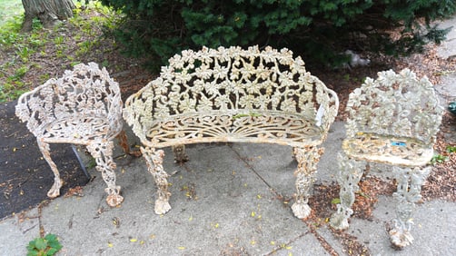 A 3 piece cast iron grape and vine pattern garden set, layers of old paint, consisting of a settee