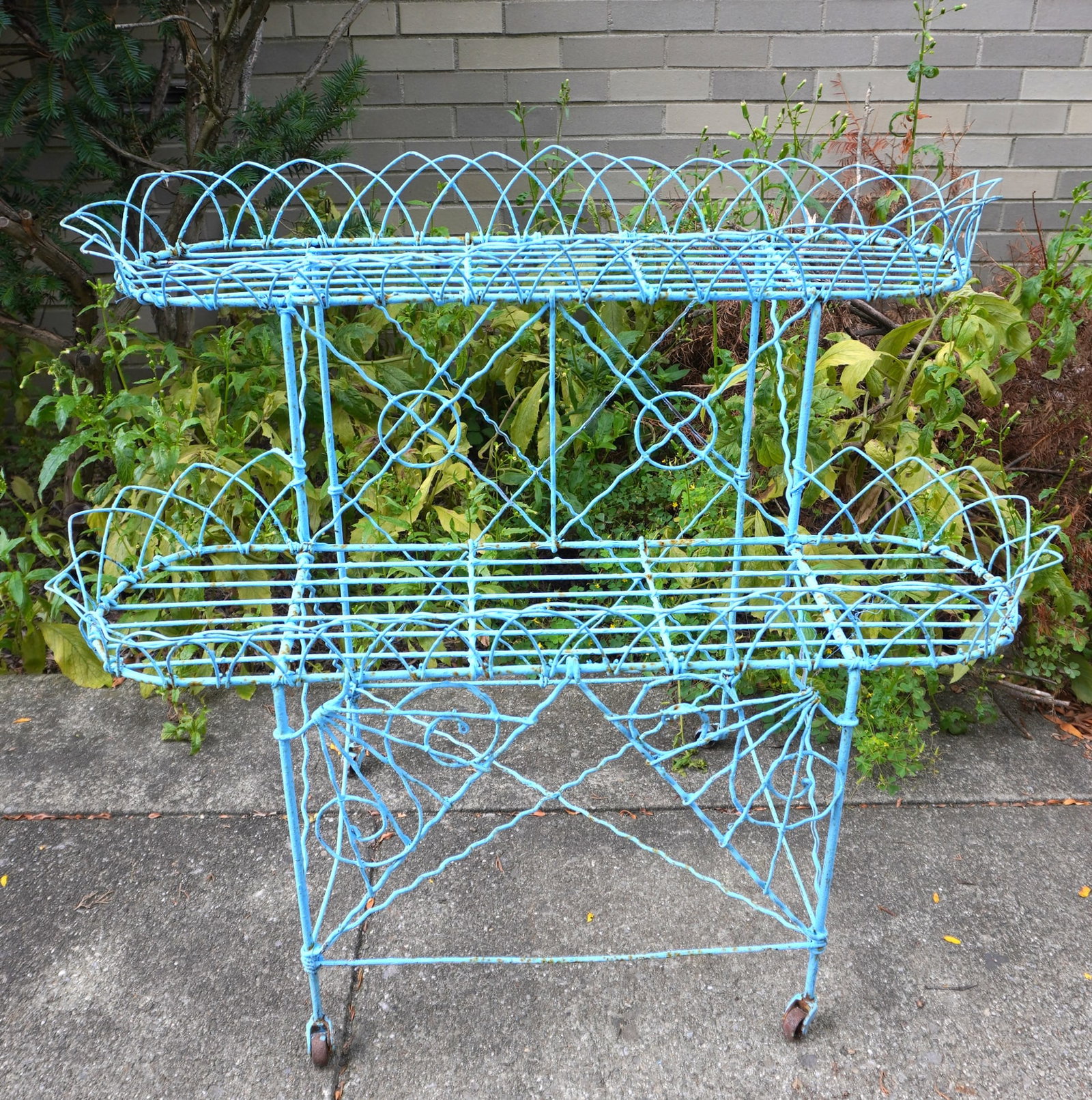 A Victorian wire 2 tier planter on original wheels, 19th century, in old blue paint. Measures 33"W x: A Victorian wire 2 tier planter on original wheels, 19th century, in old blue paint. Measures 33"W x 17 1/2"D x 28 1/2"H. Provenance: Private collector, Southbury CT.