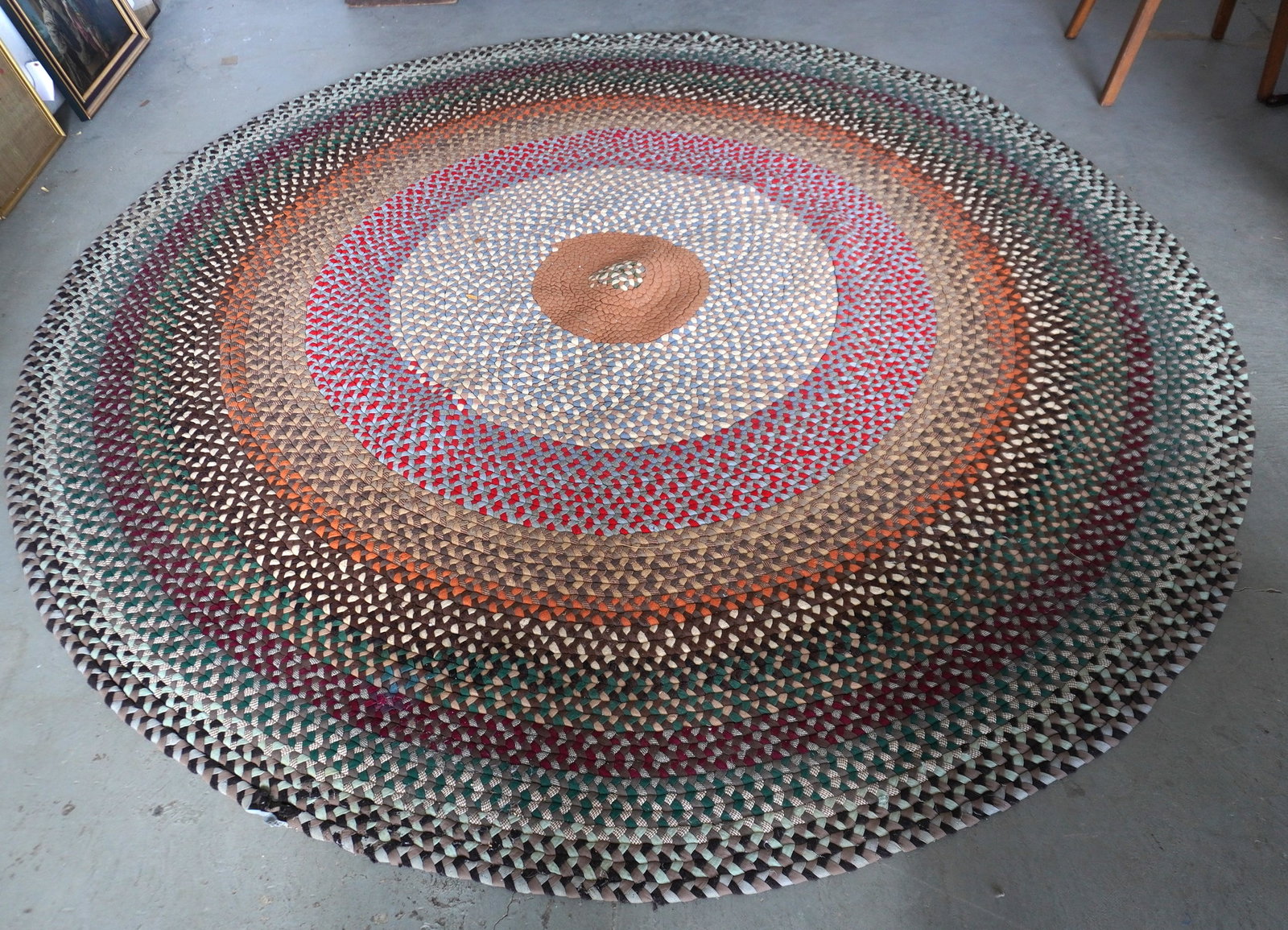 A circular room size braided rug. Small section on border slightly loose, hardly noticeable,: A circular room size braided rug. Small section on border slightly loose, hardly noticeable, otherwise in very good condition. Late 20th century. Measures 8' 10" diameter.