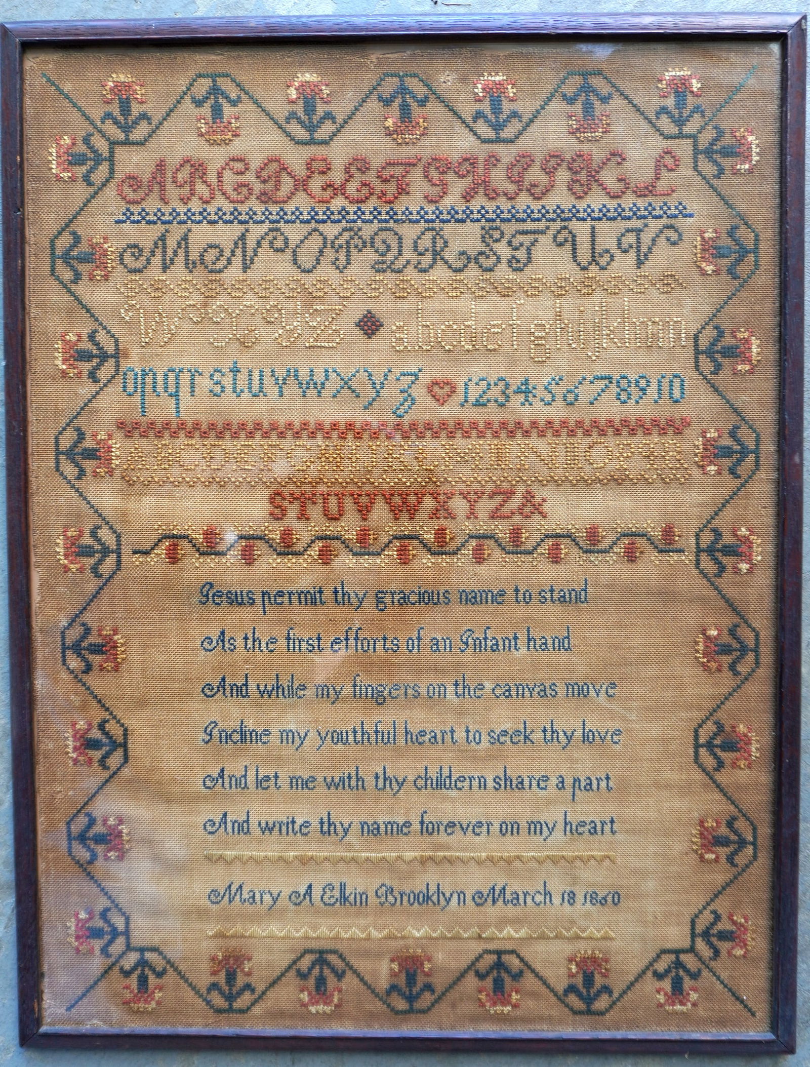 An alphabet sampler with religious verse signed "Mary A. Elkin / Brooklyn / March 18 1860". Darkened: An alphabet sampler with religious verse signed "Mary A. Elkin / Brooklyn / March 18 1860". Darkened linen, minor wear/loss top edge, else good condition. Total frame size 17" x 22". Provenance: From