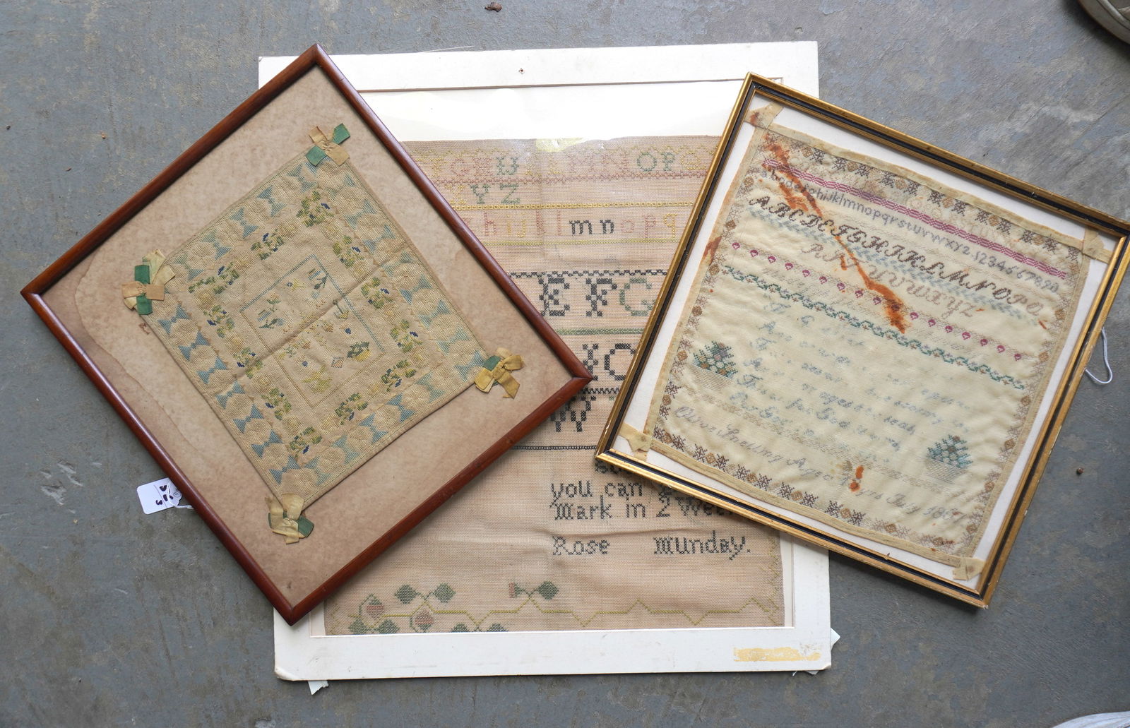 Three 19th century samplers. The first housed in a frame and is unsigned and shows various works of: Three 19th century samplers. The first housed in a frame and is unsigned and shows various works of the child - the sampler itself measures 9 1/2" x 10 1/2"; the second, also framed, is an alphabet an