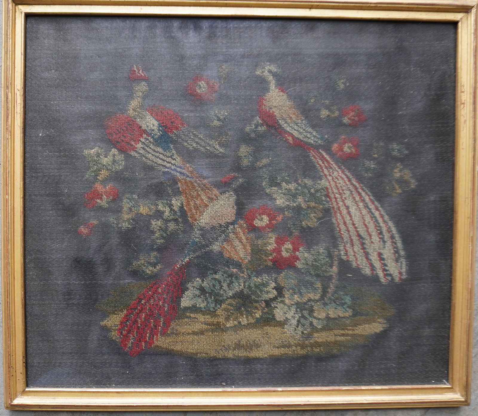An embroidery on horse hair depicting 3 exotic birds within a floral arrangement. Appears to be: An embroidery on horse hair depicting 3 exotic birds within a floral arrangement. Appears to be housed in original lemon gold frame, 19th century in very good condition. Total frame size 14 1/4" x 16