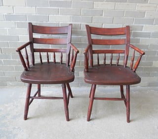 A pair of half spindle-back arm chairs with curved backs, rabbit ears, and Windsor type shaped