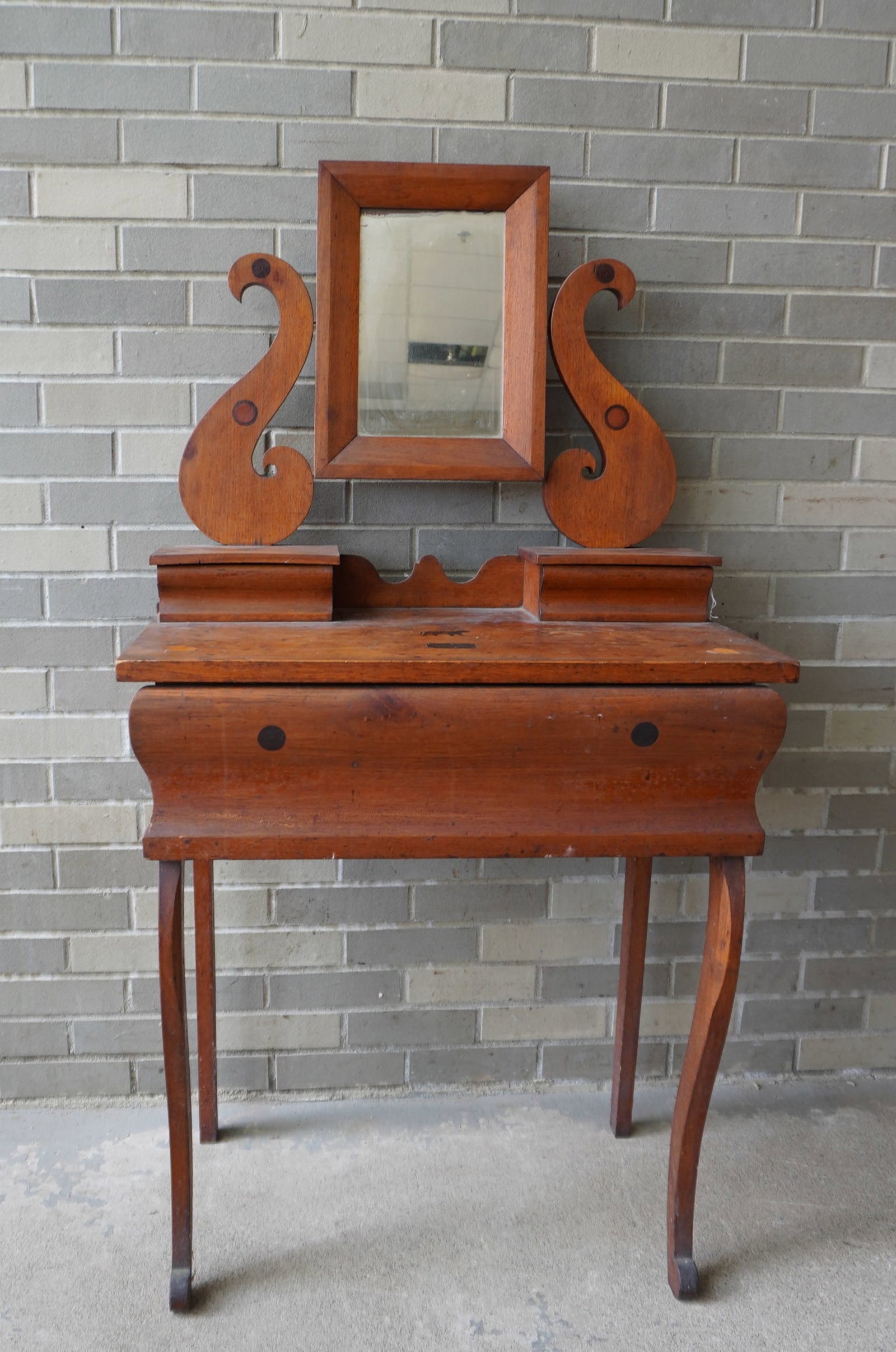 A folk art lady's dressing table with attached mirror with 2 glove boxes over 1 deep drawer, curved: A folk art lady's dressing table with attached mirror with 2 glove boxes over 1 deep drawer, curved legs leading to scrolled feet. Note the inlays of hearts, circles, diamond within medallion and a mo