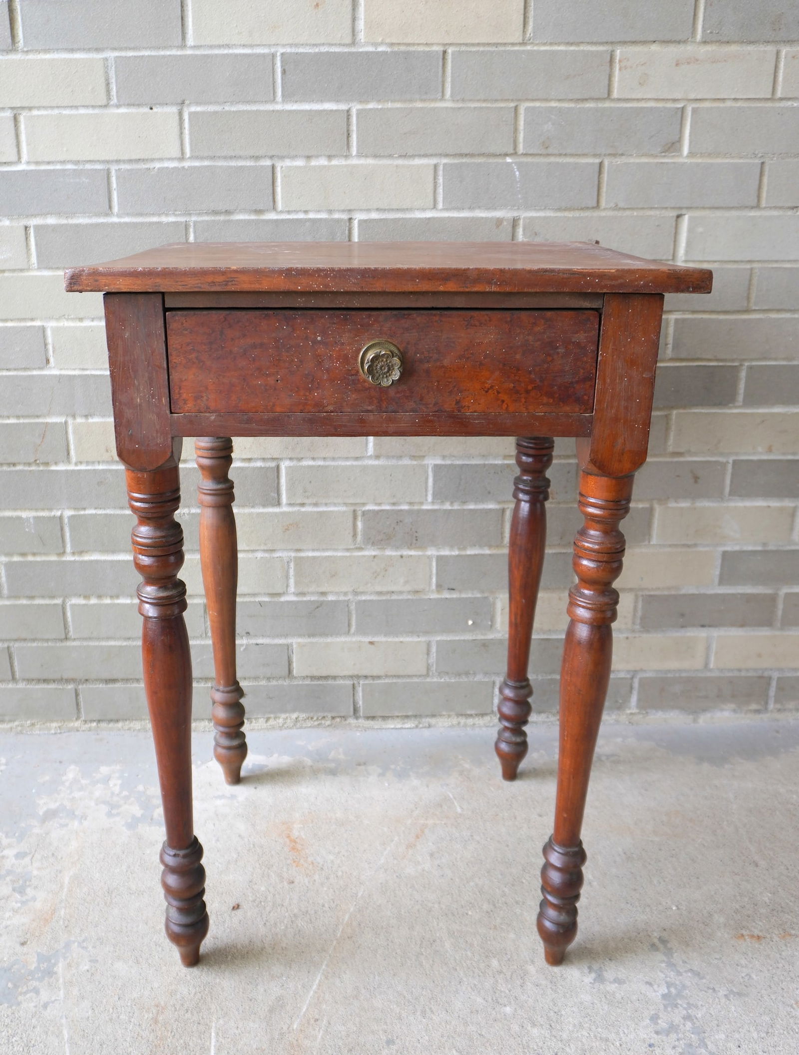 A Sheraton 1 drawer stand with birdseye maple drawer and apron, cherry frame, circa 1820. Appears to: A Sheraton 1 drawer stand with birdseye maple drawer and apron, cherry frame, circa 1820. Appears to retain original brass rosette pull. Measures 20"W x 17 1/2"D x 29"H. Needs cleaning but overall str