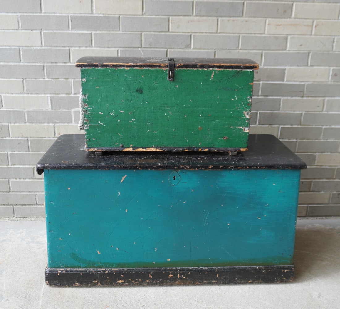 Two primitive sea chests in old paint, both with sailor made beckets. The first, a miniature chest: Two primitive sea chests in old paint, both with sailor made beckets. The first, a miniature chest with dome top, dovetailed case, in old black and green paint with hand forged iron hasp and hinges - 