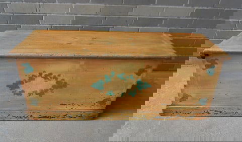 An early American sea chest, in old mustard paint with green floral decorations, over original