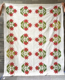 A very fine applique quilt in the Carolina Lily pattern, and having a quilted sunflower border. Note