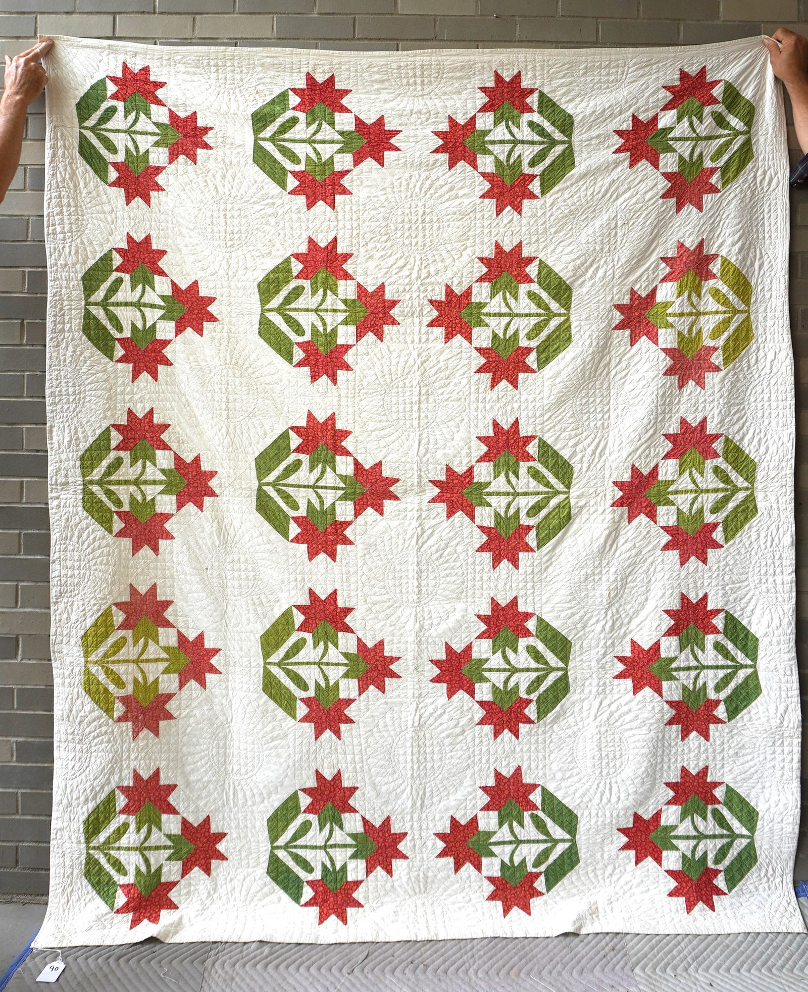 A very fine applique quilt in the Carolina Lily pattern, and having a quilted sunflower border. Note: A very fine applique quilt in the Carolina Lily pattern, and having a quilted sunflower border. Note the very fine quilting approximately 8 stitches/inch. Circa mid to late 19th century. Measures 77" 